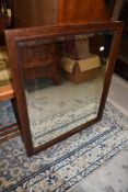 An early 20th Century oak wall mirror