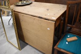 A 19th Century stripped pine drop leaf kitchen table