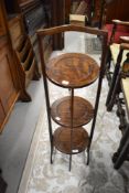 An early 20th Century oak and ply cake stand