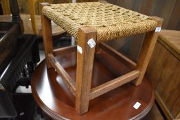 A traditional oak framed string top stool