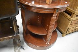 A reproduction mahogany revolving bookcase