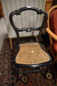 A Victorian laquered bedroom chair having mother of pearl inlay decoration