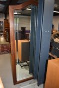 An early 20th century three section wardrobe in oak having a French carved style with cabriole