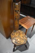 A Victorian spinning chair having mythical poker work design on turned mahogany frame