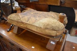 A Camel or foot stool having tooled leather top