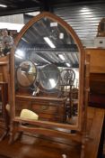 A Golden oak Art and Crafts era dressing table or toilet mirror having a Gothic design