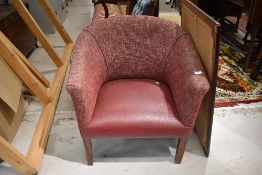 An Art Deco style tub chair having leatherette seat and burgundy upholstery on square legs