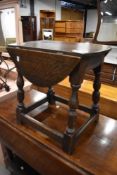 A 20th century oak coffee table with fold out top