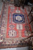 A silk carpet rug in red ground with a Chinese design
