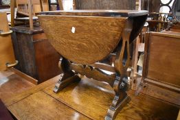 A late Victorian coffee table with drop leaf revolving top