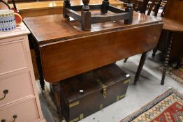 A Victorian Mahogany drop leaf dining table with turned legs
