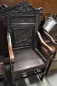 A Victorian carver chair in oak frame with carved back and rails
