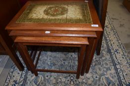 A vintage nest of three tile top occasional tables