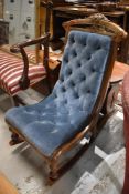 A Victorian nursing rocking chair with button back upholstery