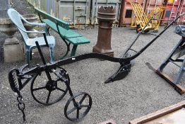 A vintage single furrow horse drawn hand driven plough