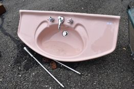 A large Art Deco style enamelled sink, in pink