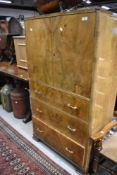 An Art Deco burr wood fronted tall chest of three drawers with cupboard
