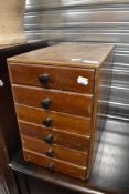 A small chest of six drawers containing some artist supplies