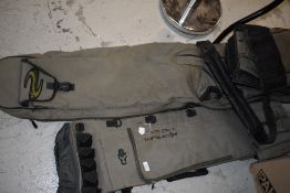 A Korum padded transportation bag and a Korum 5 rod quiver