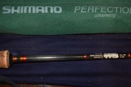 A Shimano perfection graphite 10ft fly fishing rod in original sleeve and a Hardy Fibatube 9ft 2