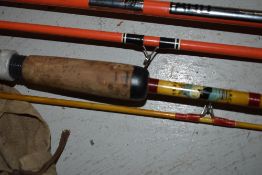 An Abu Colorit super zoom vintage 2 pc spinning rod, and a 2pc fiberglass rod marked Black Seal