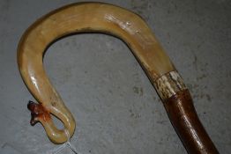 A shepards crook with a foxes head carved into the handle