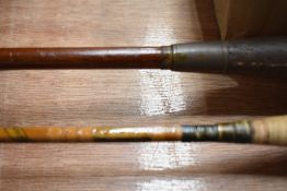 A vintage three piece split cane fly rod and Edgar Sealy live fibre fly rod in sleeves.