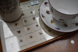 A Framed collection of North country flies with a staffordshire transfer printed tankard and a