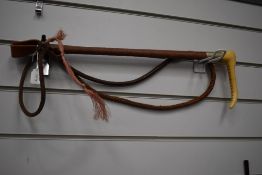 A vintage hunting whip marked swaine