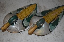 Two wooden decoy ducks