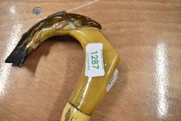 A walking stick with trout carved into handle