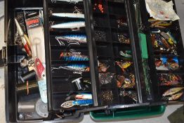 A fishing tackle box containing a large collection of lures and spinners varying in size
