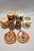 A selection of Australian Aboriginal decorated ceramics including two bowls, cruet set and four