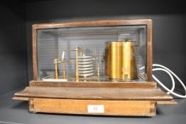 A Casella of London Barograph in wooden case and box of spare chart paper