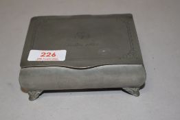 A 20th century pewter casket form jewellery case dated 1933