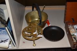 A selection of kitchenalia including lion design trivet, brass jam pan and a frying pan
