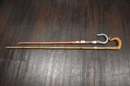 Two 20th century walking sticks one Shepherds crook with burr wood handle and a shooting stick