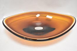 A mid century heavy set amber glass bowl