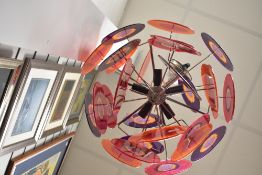 A vintage mid century Lollipop style pendant light having acrylic glitter shades