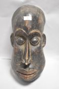 An African tribal ethnic wooden carved mask possibly in the Dogon style