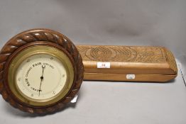 A carved wood ball holder or mould having carved decoration along with an Edwardian barometer