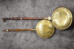 Two late Victorian bed warming pans having turned handles with brass pans