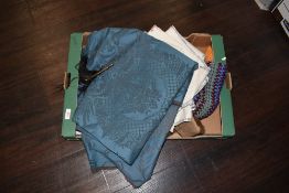 A selection of embroidered napkins and textile fabric with crotched blanket
