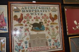 A Victorian needle work embroidery sampler with alphabet and farm animals by Emily Clement 1885