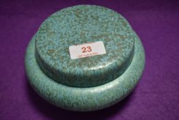 An early 20th century Royal Lancastrian studio pottery lidded container having mottled green