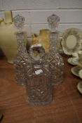 Three 20th century clear cut crystal wine or spirit decanters