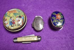 A white metal pill container with a miniature mother of pearl handle pocket knife etc