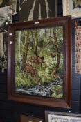 An early 20th century embroidery of deer and stag in a forest in an oak frame