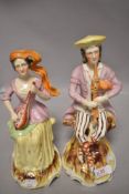 Two Victorian Staffordshire flat back figures of folk musicians one playing a flute and similar with