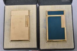 Two fine and luxury St. Dupont cigarette lighters by including guilloche worked case in yellow metal